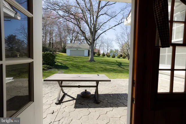 a view of a yard with a bench and garden
