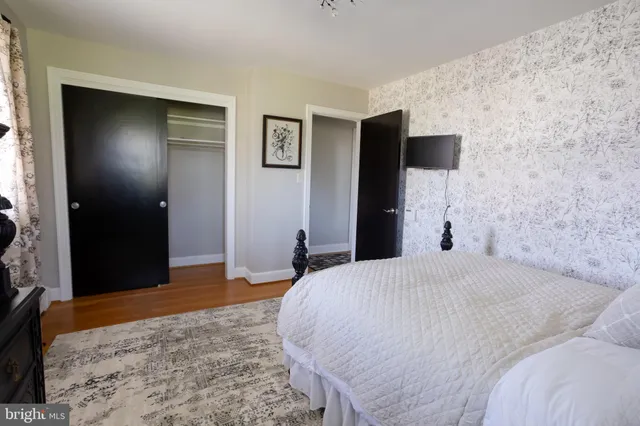 a bedroom with a bed and a television