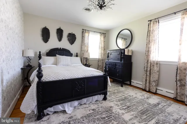 a bed sitting in a bedroom next to a window