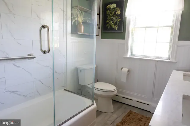 a bathroom with a toilet and a shower