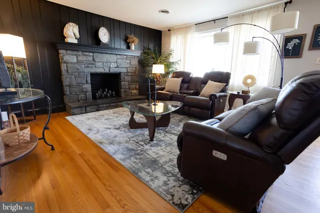 a living room with furniture and a fireplace