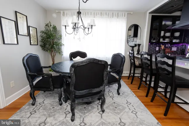 a view of a dining room with furniture and chandelier
