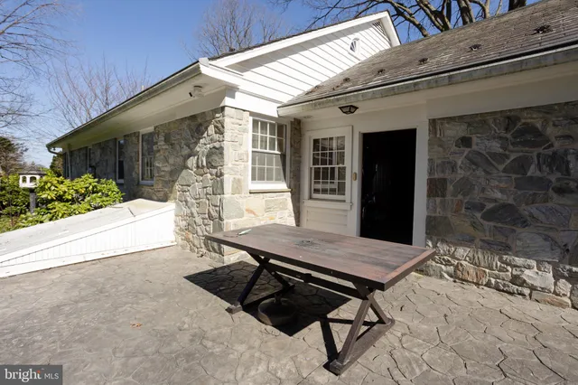 a view of backyard with a patio and wooden fence
