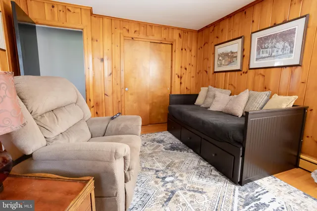 a living room with furniture and a bed
