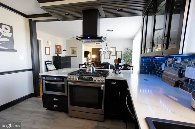 a kitchen with stainless steel appliances granite countertop a stove and a sink