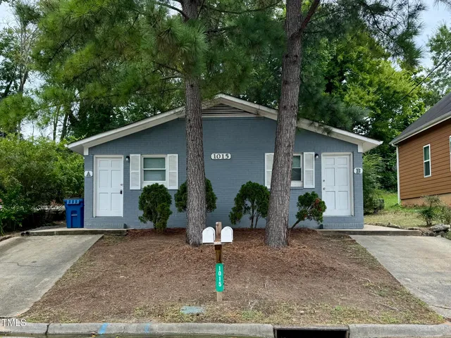 a front view of a house with a yard and a garage
