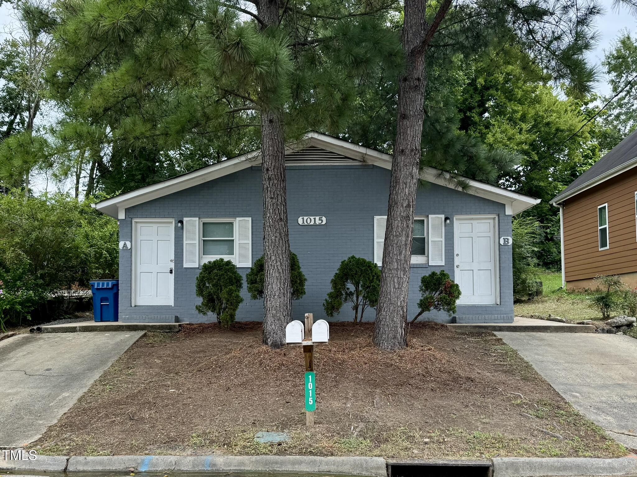 a front view of a house with a yard and a garage