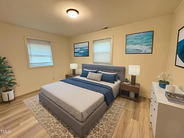 a bedroom with bed and a night stand