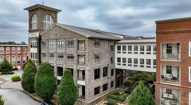 a front view of a residential apartment building with windows and entryway