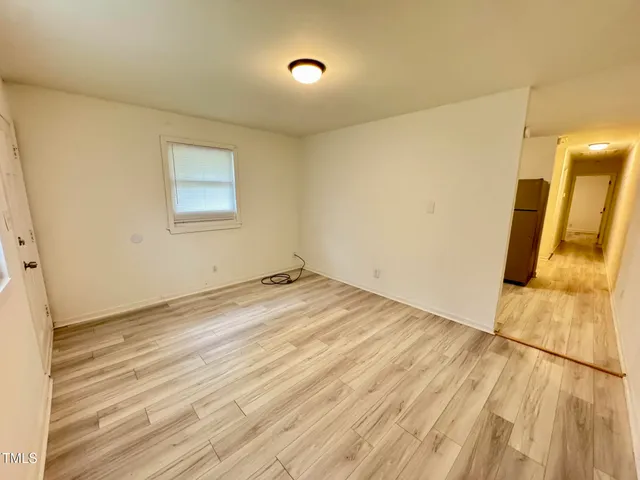 a view of a room with wooden floor and a sink