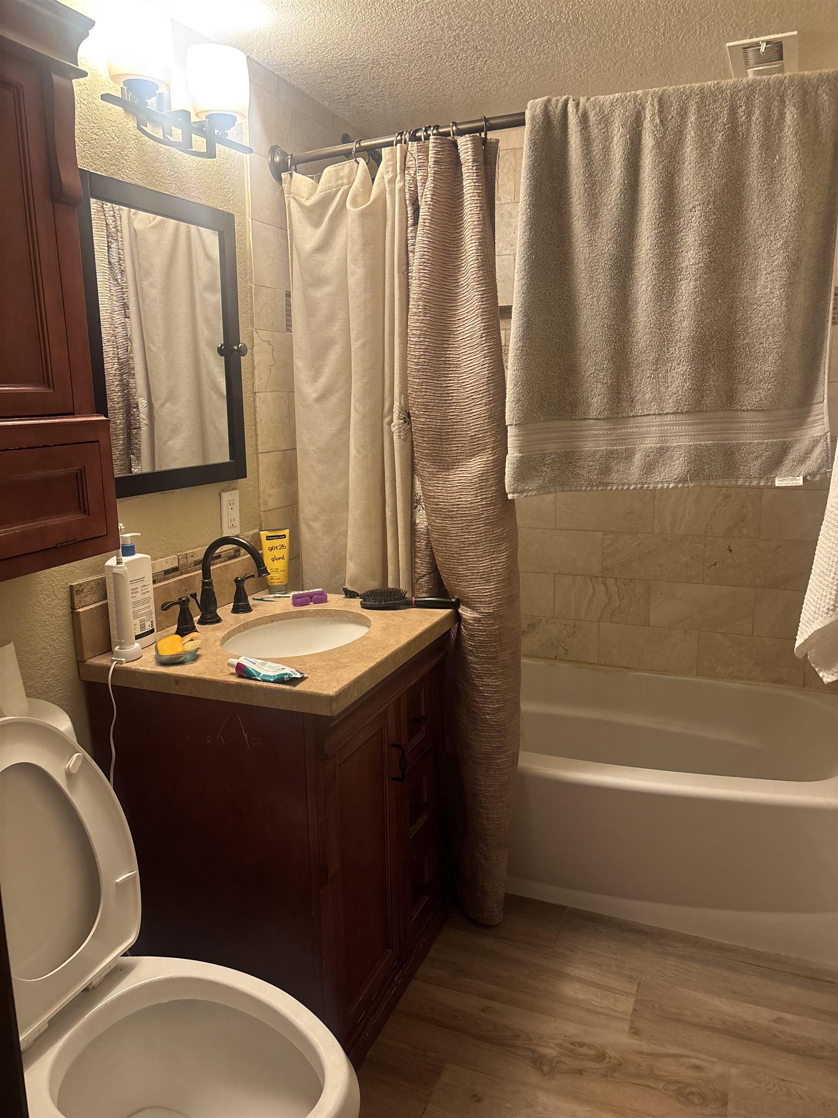 129 Sunny Slopes Road Mammoth Lakes, CA 93546 - Photo 11 of 16 Full bathroom with vanity, light wood finished floors, shower / tub combo with curtain, and a textured ceiling
