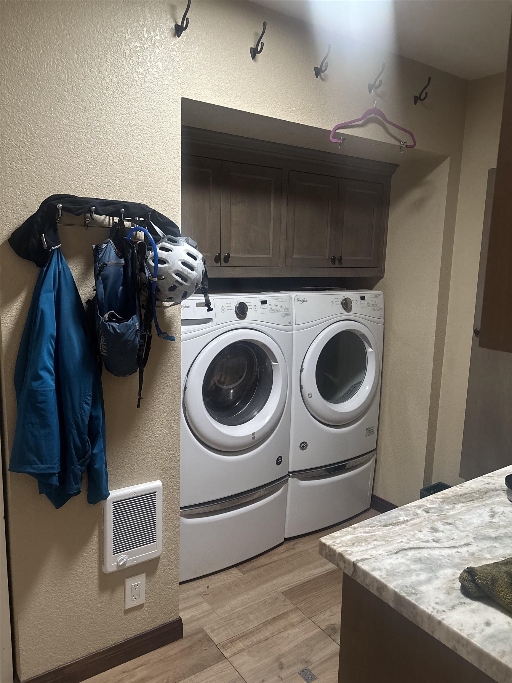 129 Sunny Slopes Road Mammoth Lakes, CA 93546 - Photo 16 of 16 Laundry area with a textured wall, cabinet space, light wood-style flooring, heating unit, and independent washer and dryer
