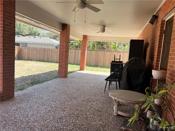 a view of a porch with furniture and a backyard