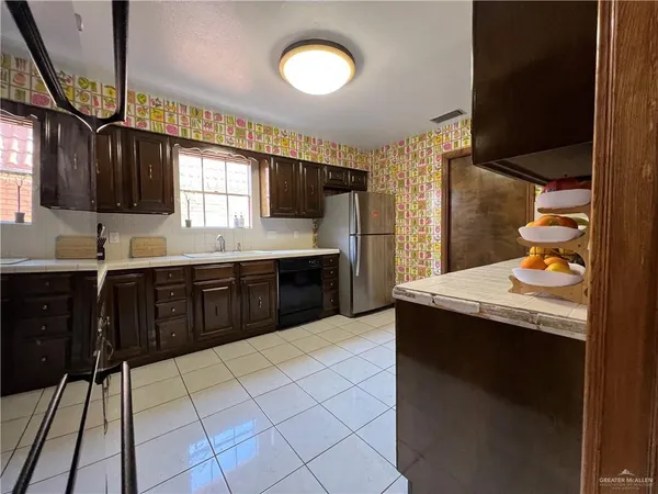 a kitchen with stainless steel appliances a sink stove and cabinets