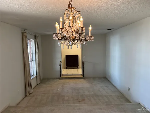 a view of a chandelier in big room and chandelier