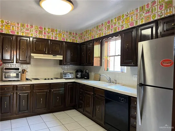 a kitchen with a sink window and cabinets