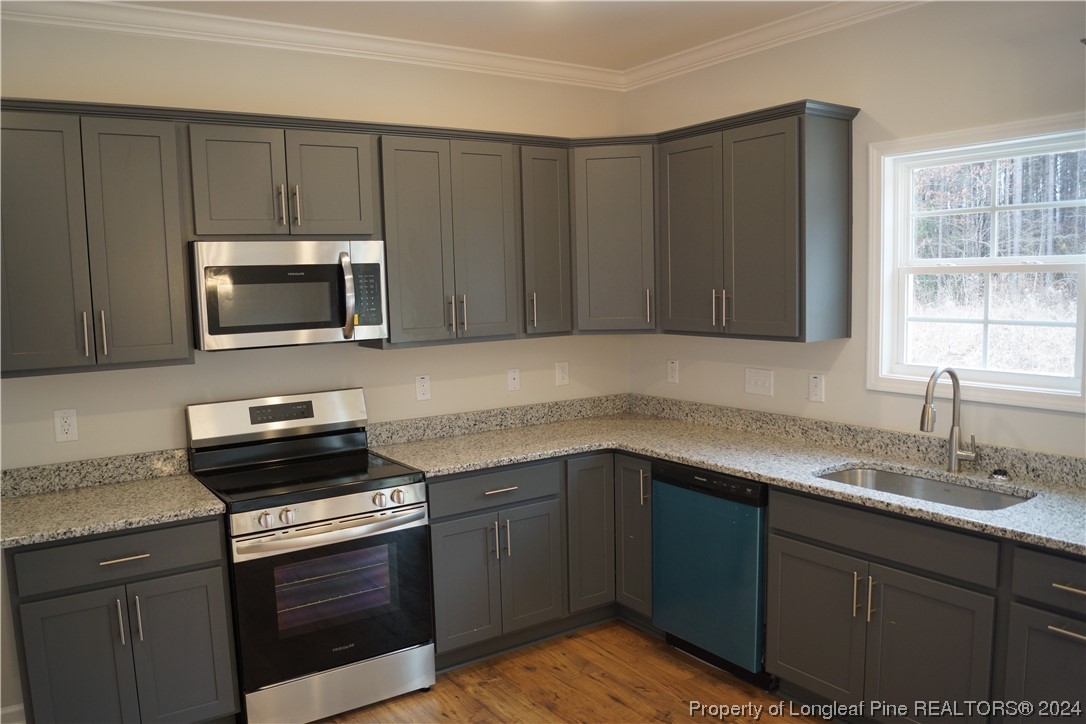 88 Knotts Berry Road Bunnlevel, NC 28323 - Photo 14 of 33 a kitchen with a sink stove and microwave