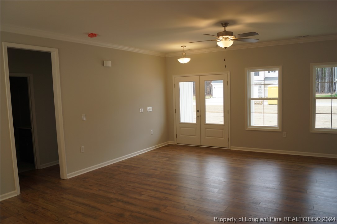 88 Knotts Berry Road Bunnlevel, NC 28323 - Photo 17 of 33 a view of an empty room with glass door and wooden floor