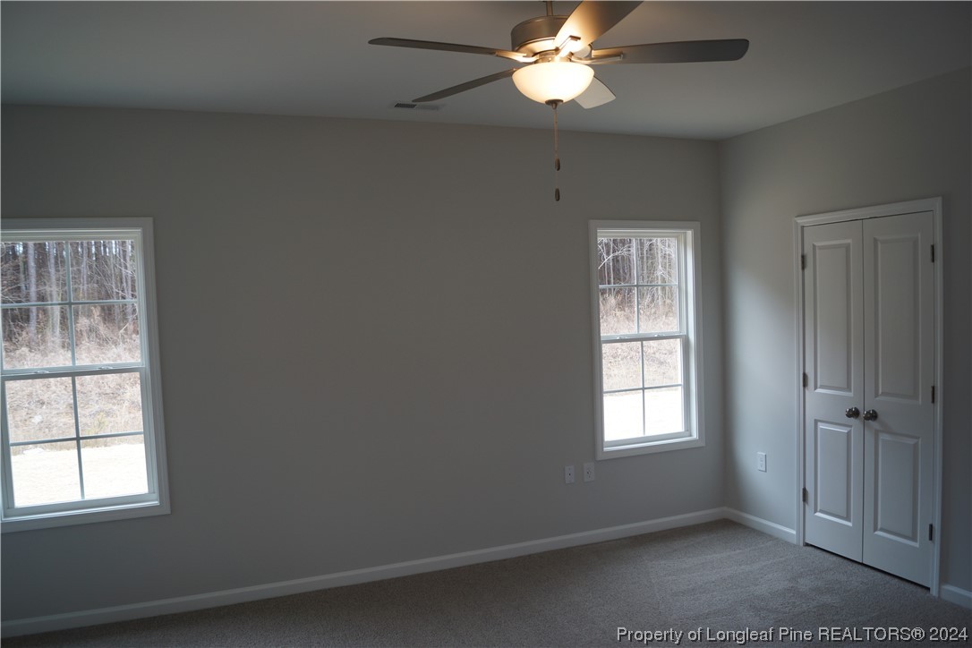 88 Knotts Berry Road Bunnlevel, NC 28323 - Photo 19 of 33 an empty room with windows and fan