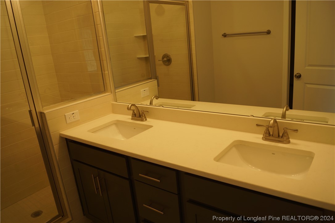 88 Knotts Berry Road Bunnlevel, NC 28323 - Photo 20 of 33 a bathroom with a sink and a mirror