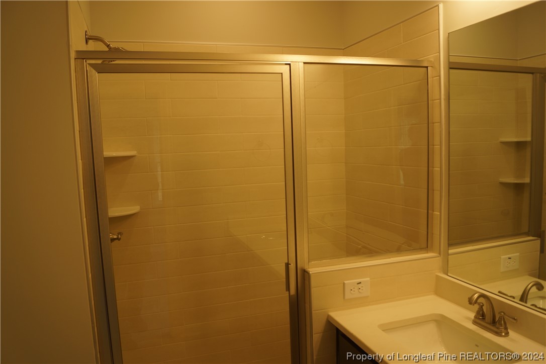 88 Knotts Berry Road Bunnlevel, NC 28323 - Photo 21 of 33 a bathroom with a shower and a sink