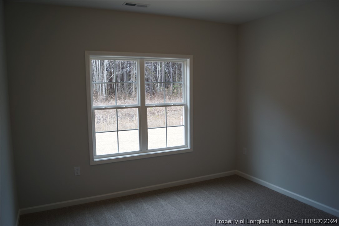 88 Knotts Berry Road Bunnlevel, NC 28323 - Photo 30 of 33 an empty room with a window