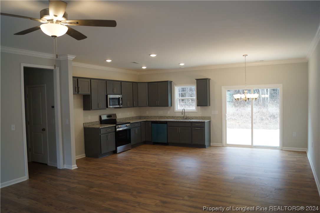88 Knotts Berry Road Bunnlevel, NC 28323 - Photo 4 of 33 a large kitchen with stainless steel appliances granite countertop a stove top oven a sink and a refrigerator