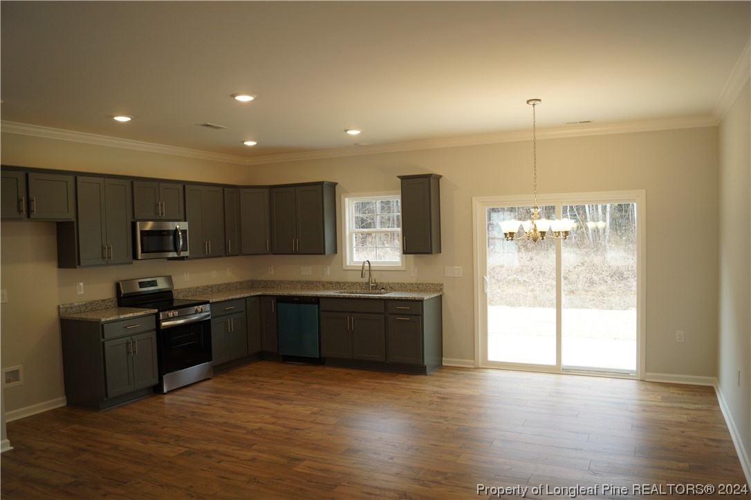 88 Knotts Berry Road Bunnlevel, NC 28323 - Photo 5 of 33 a large kitchen with stainless steel appliances granite countertop a stove a sink and a refrigerator