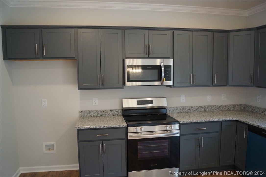 88 Knotts Berry Road Bunnlevel, NC 28323 - Photo 10 of 33 a kitchen with granite countertop cabinets stainless steel appliances and a counter space