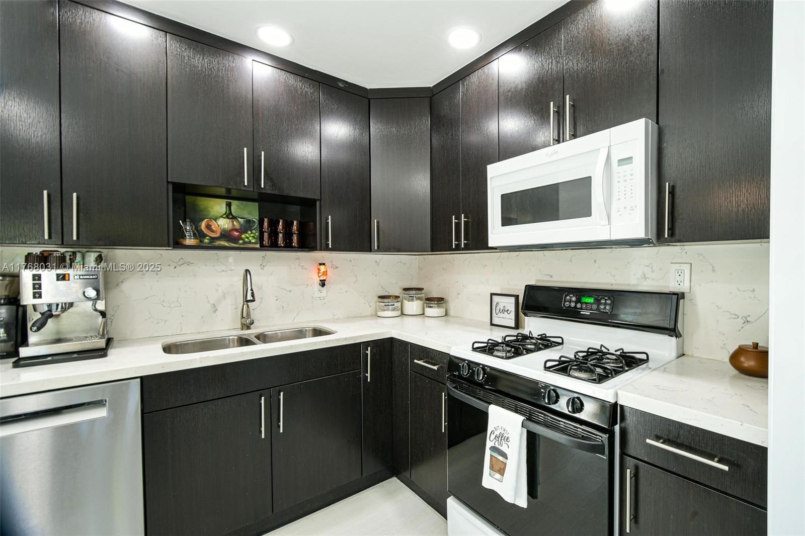 2001 North 31st Road Hollywood, FL 33021 - Photo 12 of 75 a kitchen with stainless steel appliances a sink stove and cabinets
