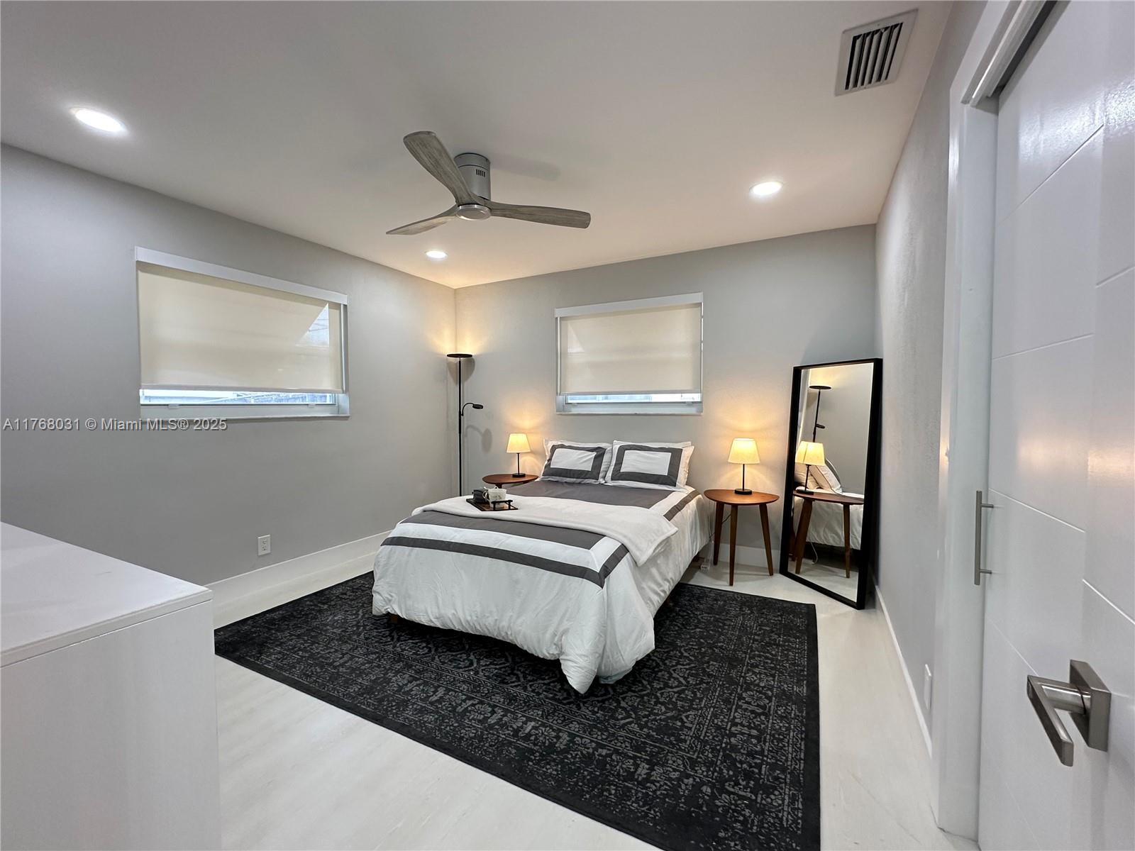 2001 North 31st Road Hollywood, FL 33021 - Photo 16 of 75 a living room with a bed furniture and a large mirror