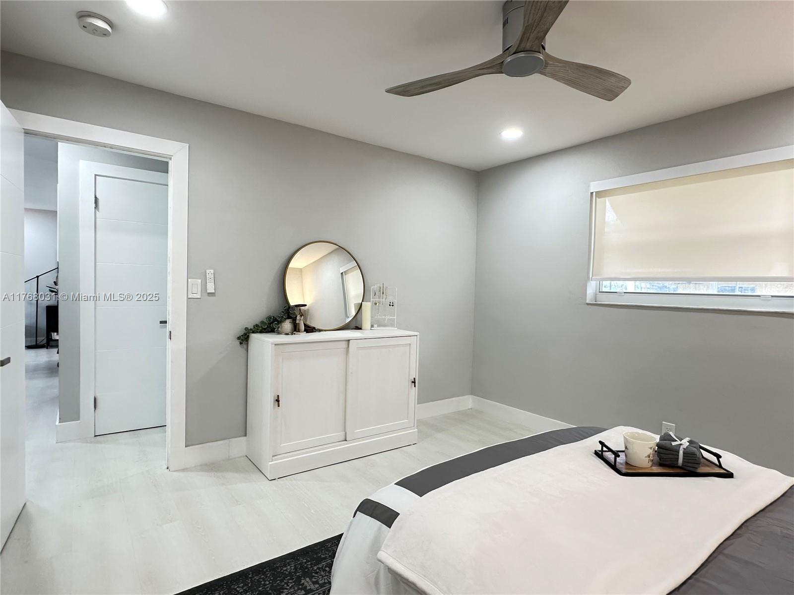 2001 North 31st Road Hollywood, FL 33021 - Photo 18 of 75 a bedroom with a bed and a chandelier