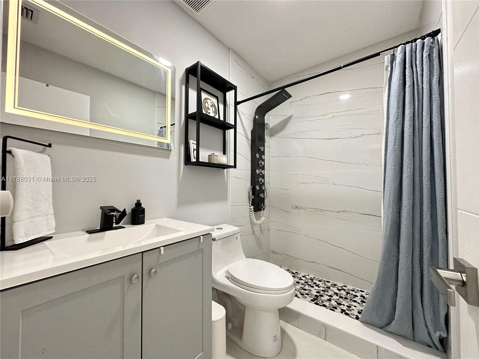 2001 North 31st Road Hollywood, FL 33021 - Photo 21 of 75 a bathroom with a sink a toilet and shower