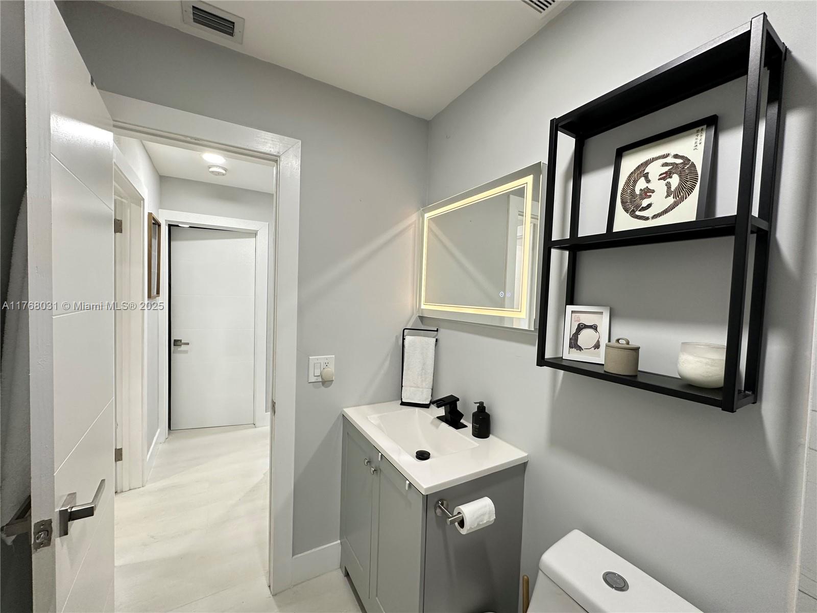 2001 North 31st Road Hollywood, FL 33021 - Photo 24 of 75 a bathroom with a toilet sink and mirror