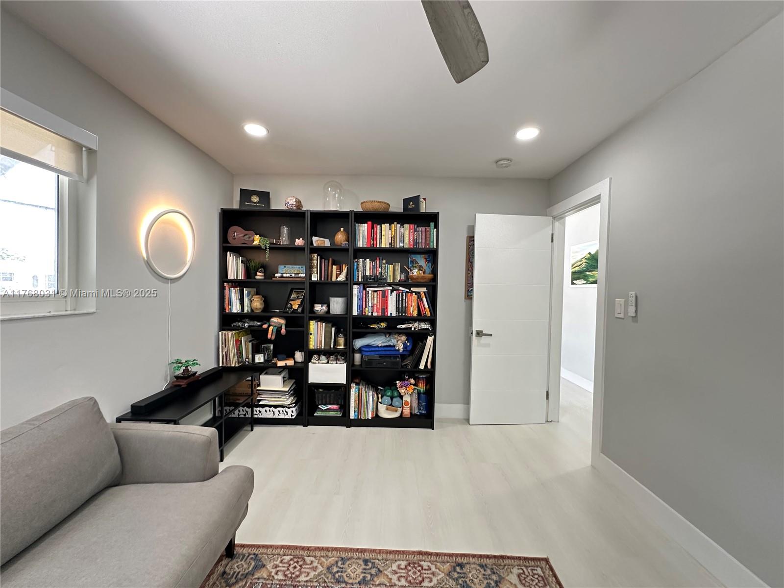2001 North 31st Road Hollywood, FL 33021 - Photo 27 of 75 a living room with furniture and a book shelf