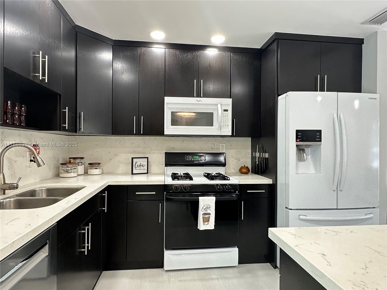 2001 North 31st Road Hollywood, FL 33021 - Photo 35 of 75 a kitchen with stainless steel appliances granite countertop a sink stove and refrigerator