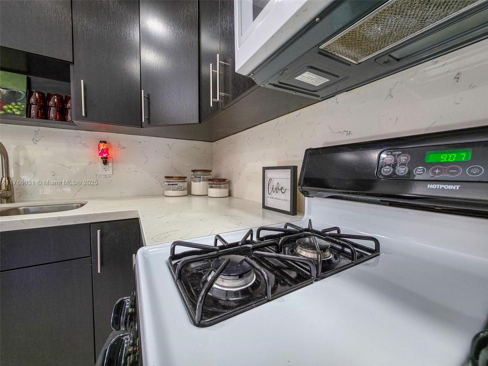 2001 North 31st Road Hollywood, FL 33021 - Photo 37 of 75 a kitchen with a sink and a stove top oven