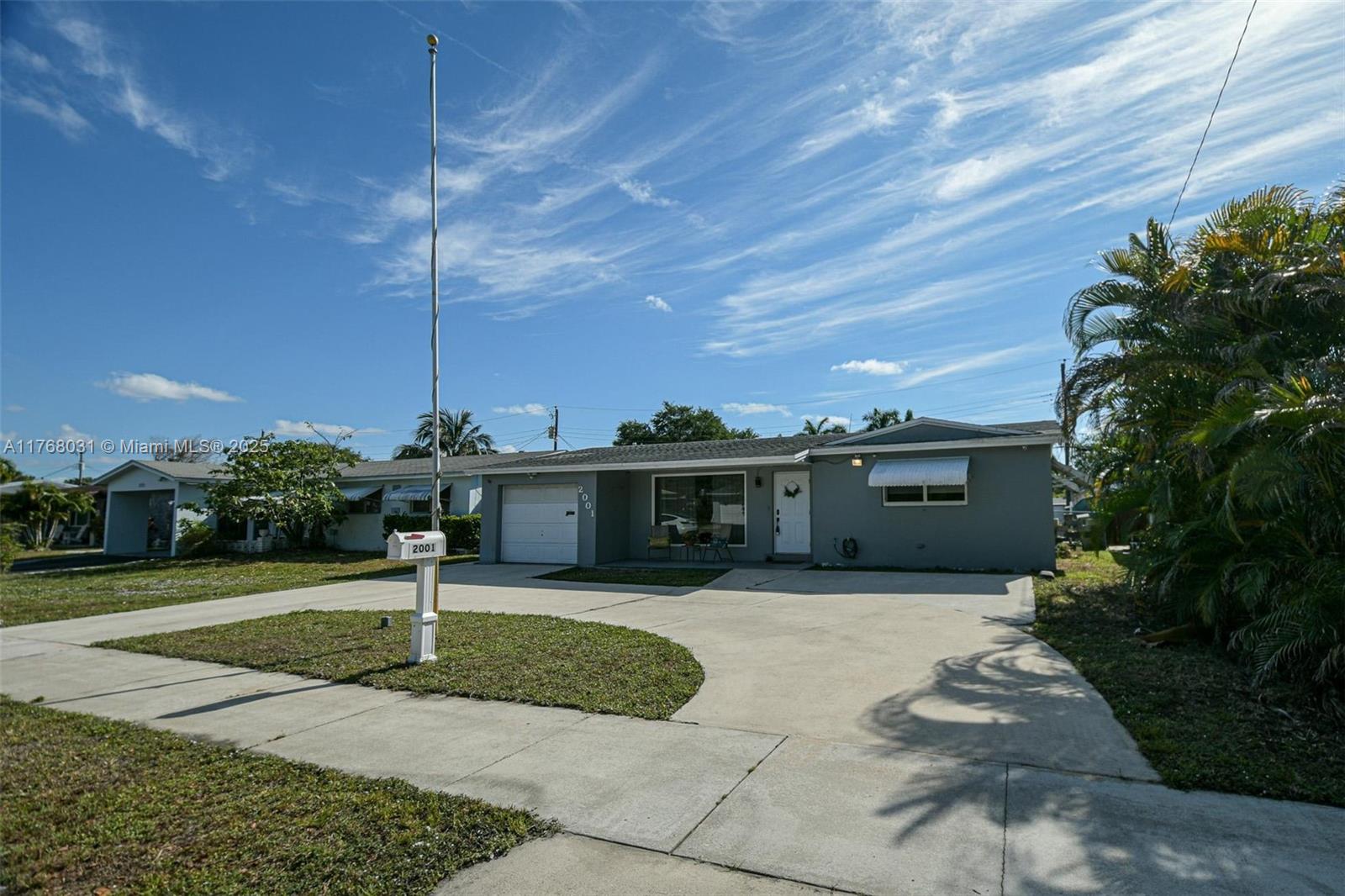 2001 North 31st Road Hollywood, FL 33021 - Photo 5 of 75 a front view of a house with a yard and potted plants