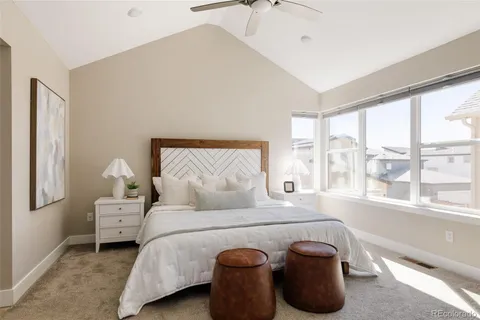 a bedroom with a bed and a large window