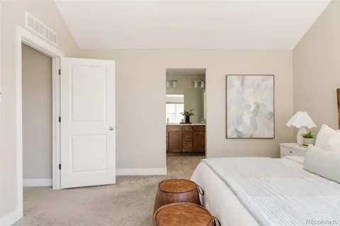 a bedroom with a bed and a couch