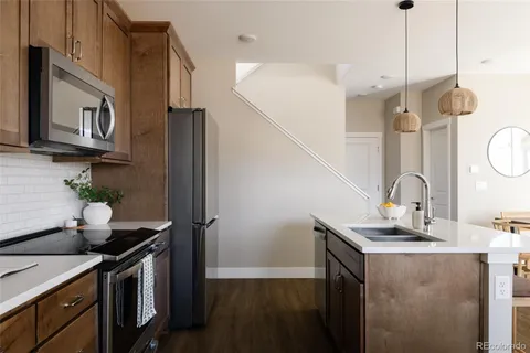 a kitchen with stainless steel appliances a sink a stove and a refrigerator