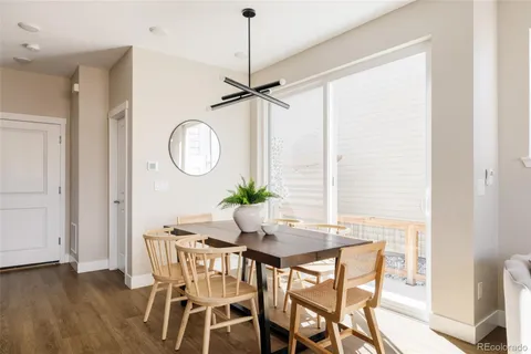 a dining room with furniture a potted plant and a chandelier
