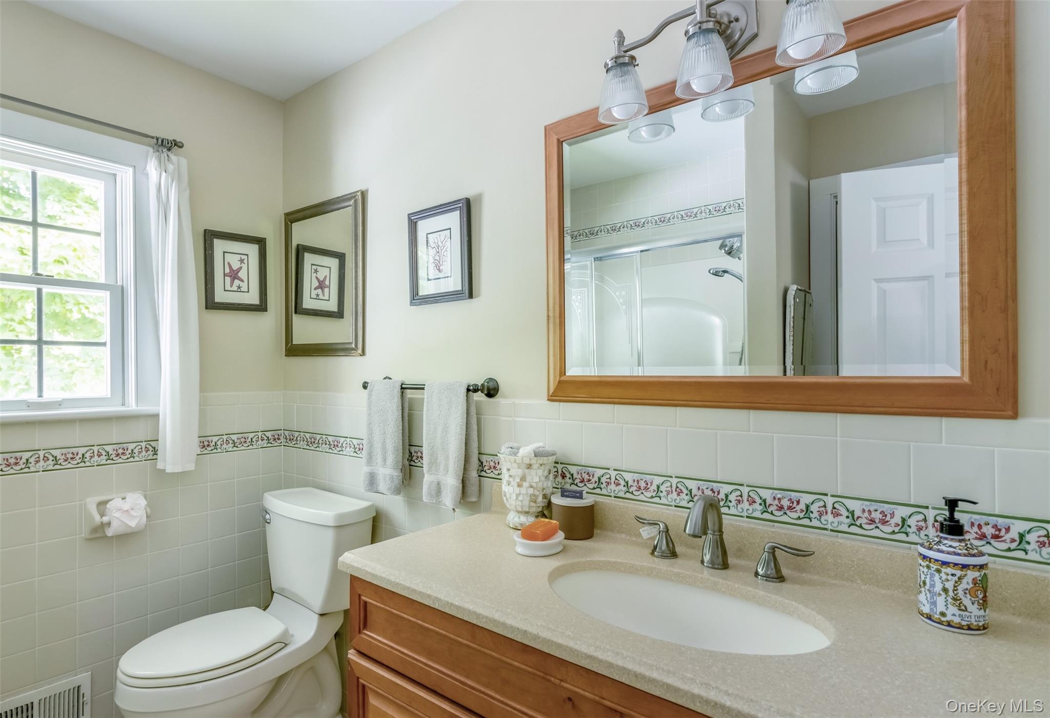 315 Wicks Road New Suffolk, NY 11956 - Photo 13 of 28 a bathroom with a sink toilet and mirror