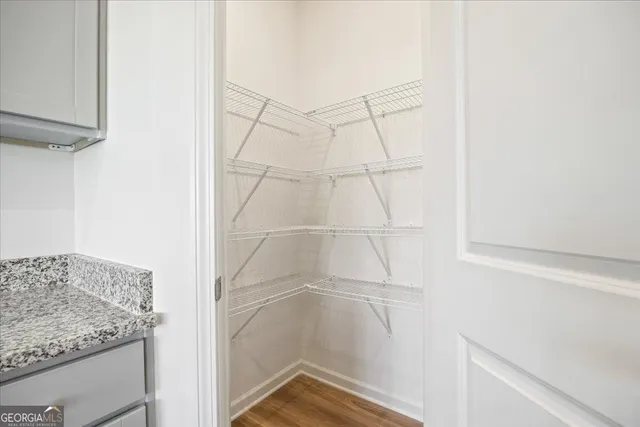 a bathroom with a granite countertop shower and a sink
