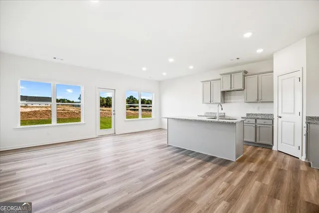 a view of kitchen with wooden floor and electronic appliances