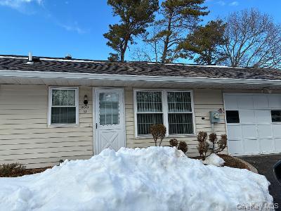 353 Woodbridge Drive Ridge, NY 11961 - Photo 3 of 11 a front view of a house with a yard and outdoor seating
