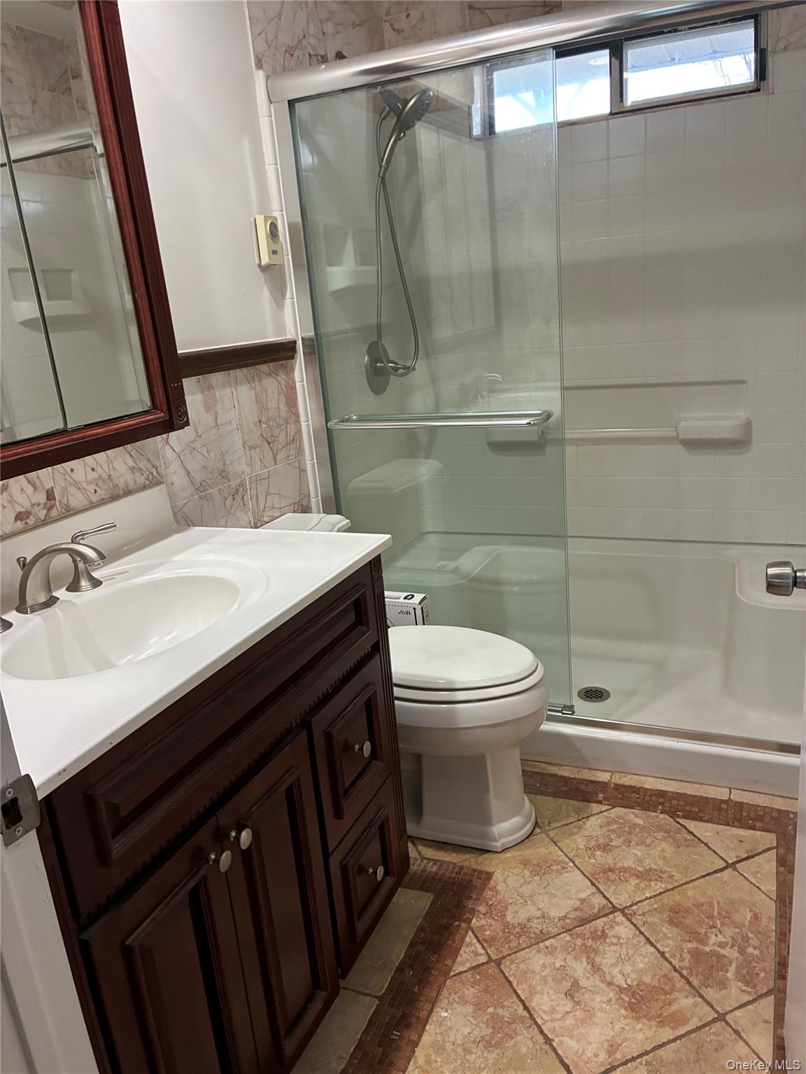 353 Woodbridge Drive Ridge, NY 11961 - Photo 9 of 11 a bathroom with a sink a toilet and a mirror