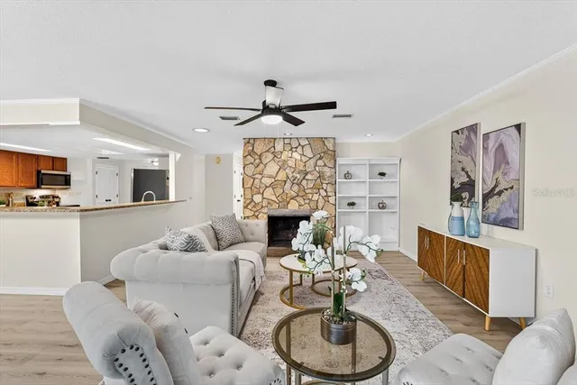 a living room with furniture a dining table and a chandelier
