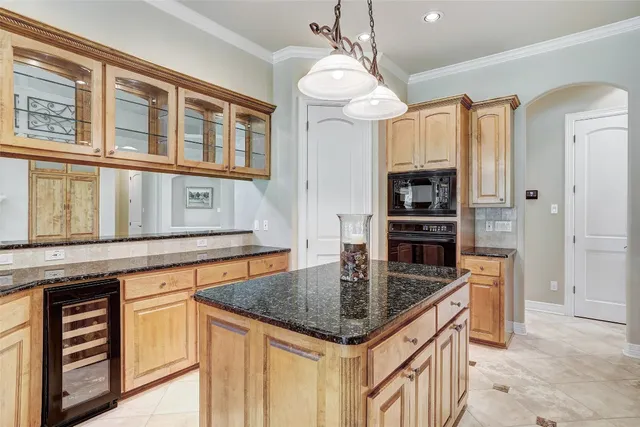 a kitchen with stainless steel appliances granite countertop a sink and a refrigerator