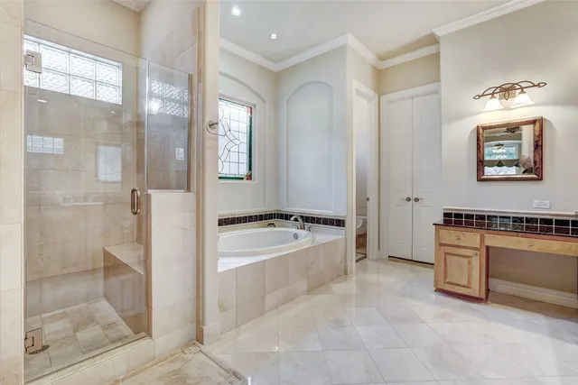 a white bath tub sitting in a bathroom next to a window